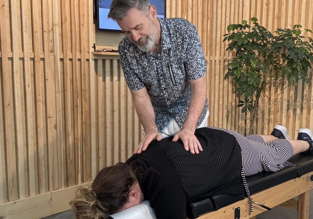 Dr Case adjusting someone in Chilliwack Dr Case adjusting a woman at the chiropractic studio in chilliwack